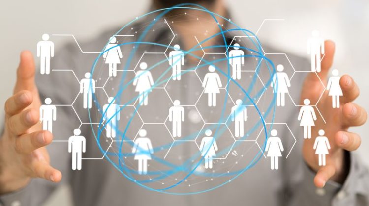 Business professional holding a digital network representing outsourced teams and business connections.