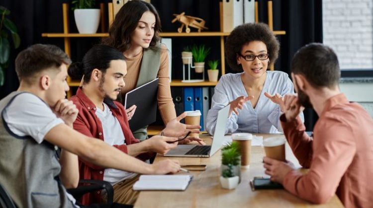 Business team discussing workplace communication and employee feedback during a meeting.