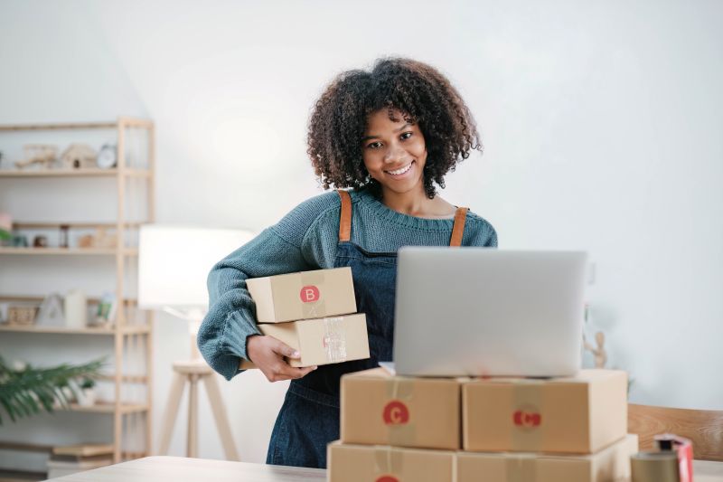 Startup small business entrepreneur SME, asian woman packing cloth in box. Portrait young Asian