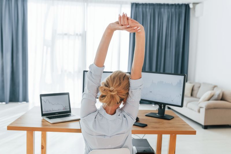 Taking a break. Female stock broker in formal wear is working in the office