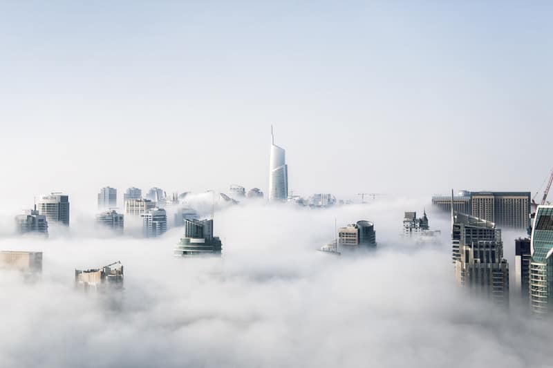 Tall skycraper buildings seen through the clouds