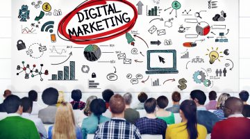 back of heads of people in a conference looking at a screen with digital marketing ideas