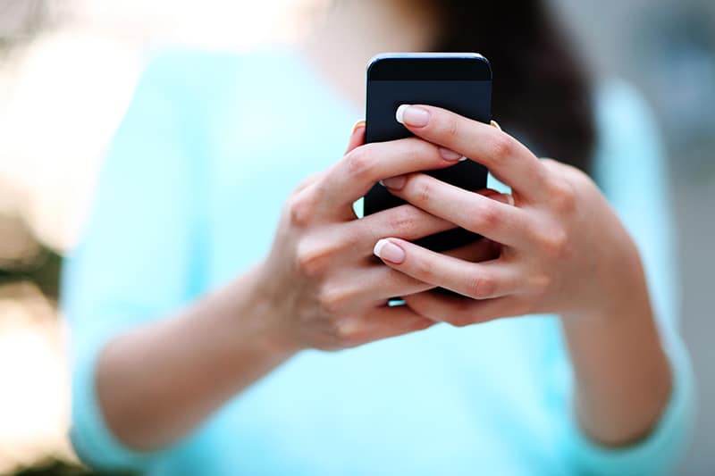 Closeup portrait of a female hands holding smartphone