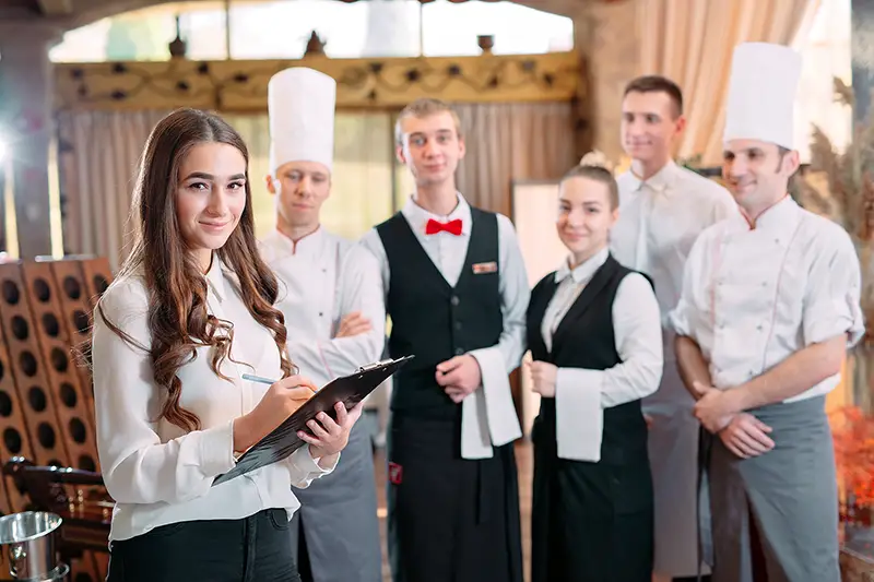 restaurant manager and his staff in kitchen