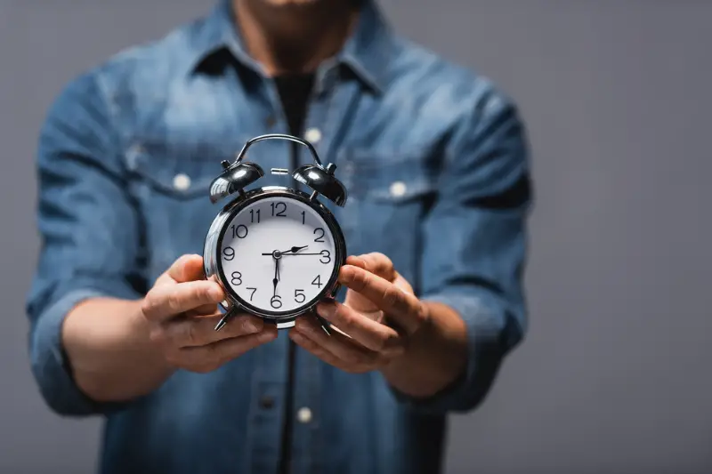 Man showing alarm clock