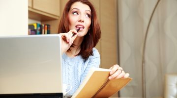 Thoughtful woman working at home