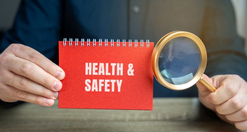 Health and Safety Concept with Magnifying Glass