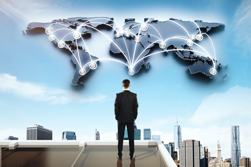 Global Social Networking Concept With Businessman Looking At Abstract Map With Network On City
