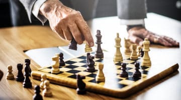 Man in gray suit playing chess