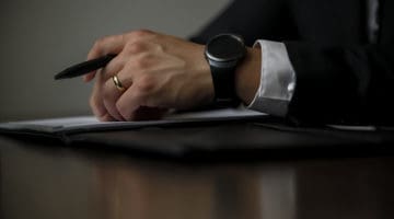 person holding a black pen