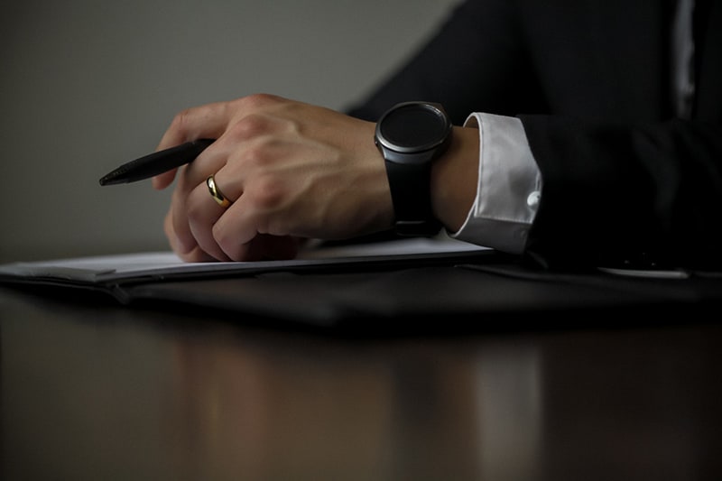 person holding a black pen