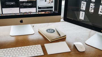 Two monitors keyboard and mouse on table