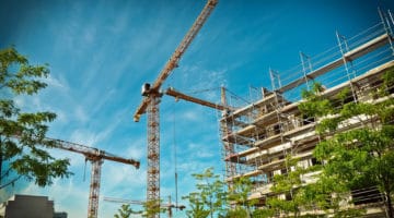 high rise building under construction, cranes