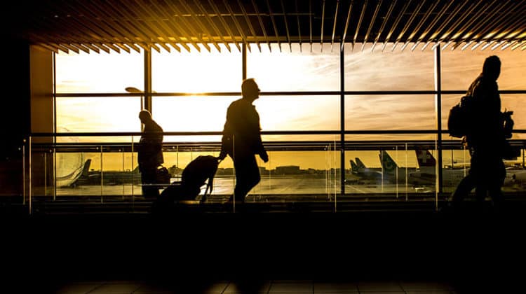 Silhouette of people in airport at dawn