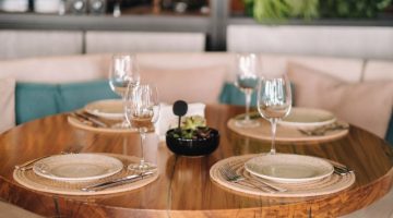 Empty dishes and cutlery on the table in the restaurant before dinner