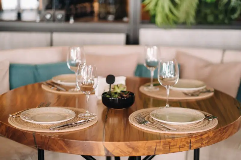 Empty dishes and cutlery on the table in the restaurant before dinner