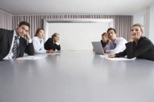 group of bored employees in a meeting room