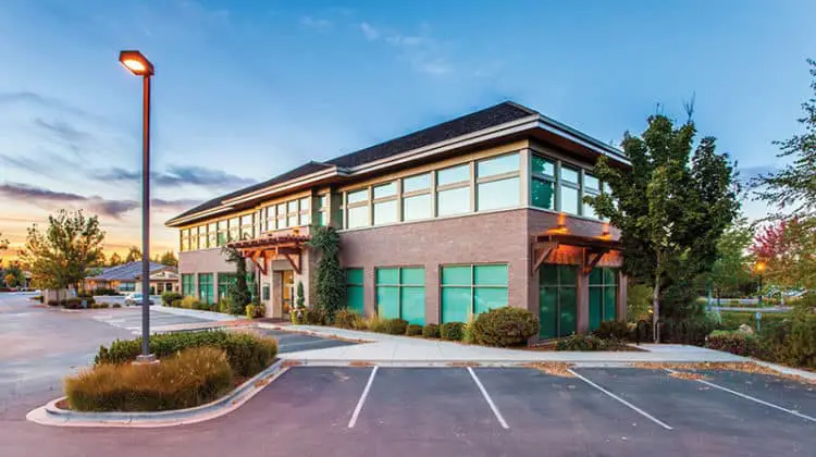 Exterior of two storey building and car park
