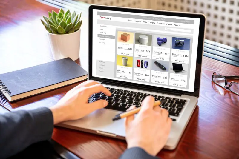 ecommerce online store shown on open MacBook Pro beside a gray mug