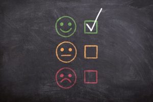 Customer feedback - happy, neutral and sad faces with tick boxes next to them