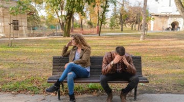 How a Private Investigator can Help your Divorce Case - man and woman upset with each other - sitting on park bench
