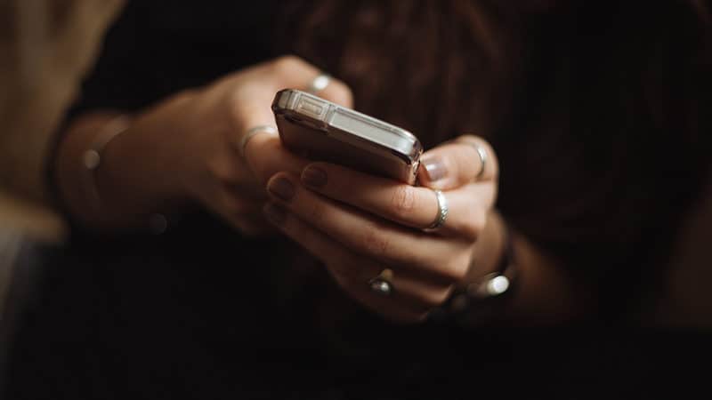 Woman using silver Iphone