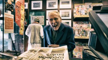 A Loyal customer buying newspapaer.