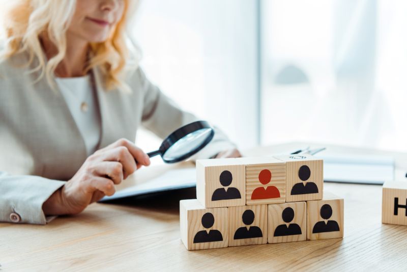 selective focus of wooden cubes near blonde recruiter