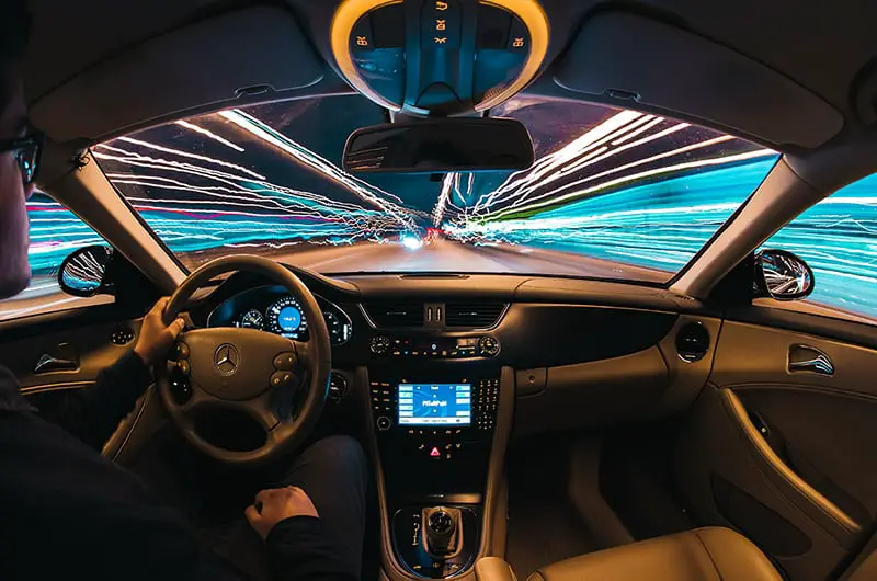 time lapse photography of man driving a car