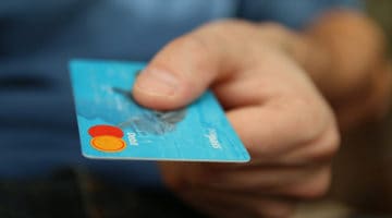 Importance of debt recovery. - person holding a credit card