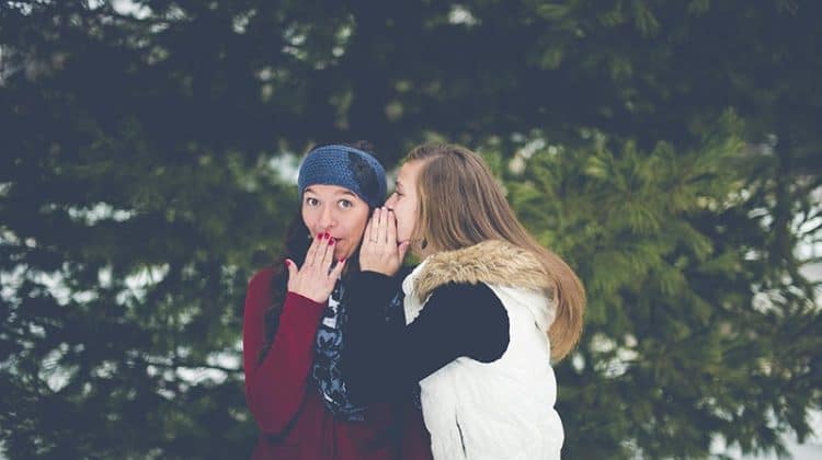 two women wispering - referral - word or mouth