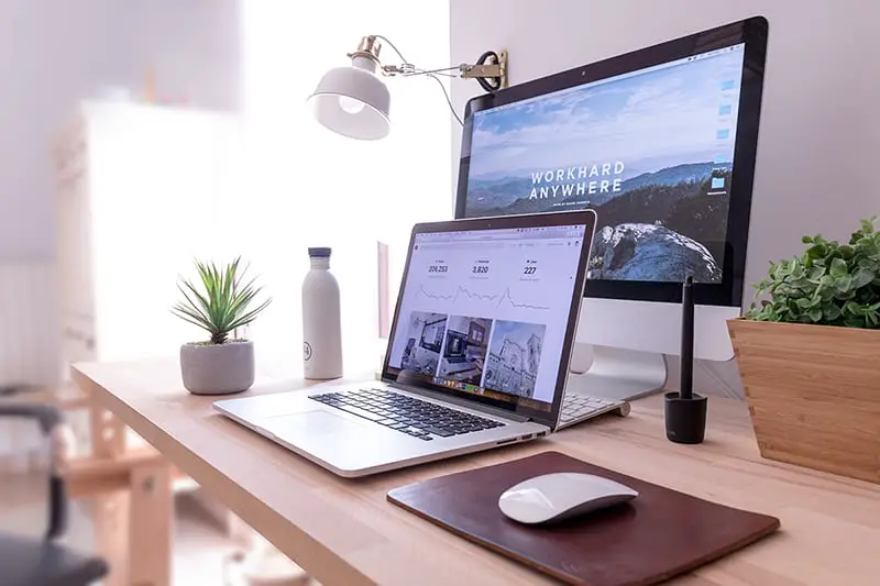 Standing desk with laptop, computer, mouse and keyboard