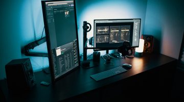 two black flat screen computer monitors on desk