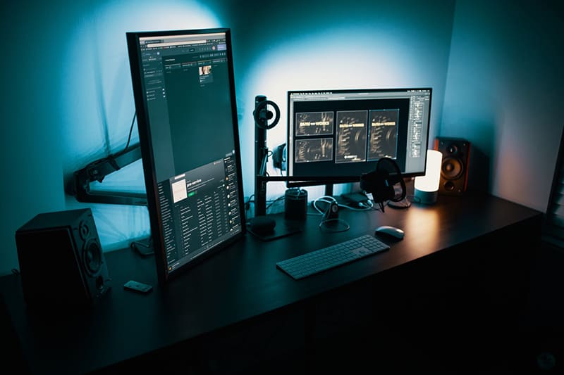 2 black flat screen computer monitors on desk
