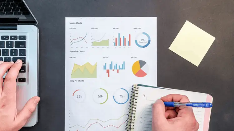 Small Business Owner Writing On Notebook