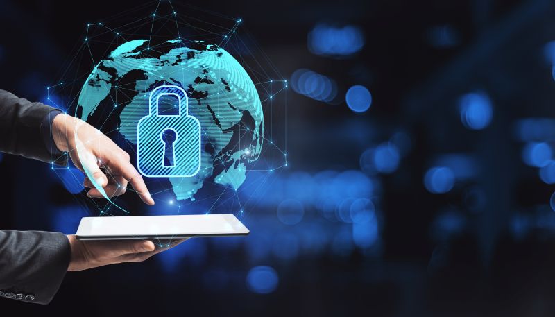 Close Up Of Hand Pointing At Smartphone With Abstract Glowing Globe Hologram With Security Padlock