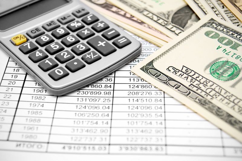 Calculator and money on the documents.