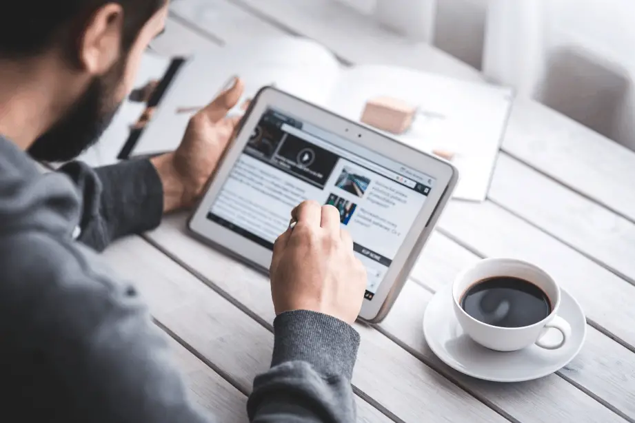 Person using website builder on tablet