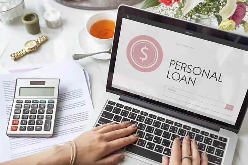 Person applying for a personal loan on laptop