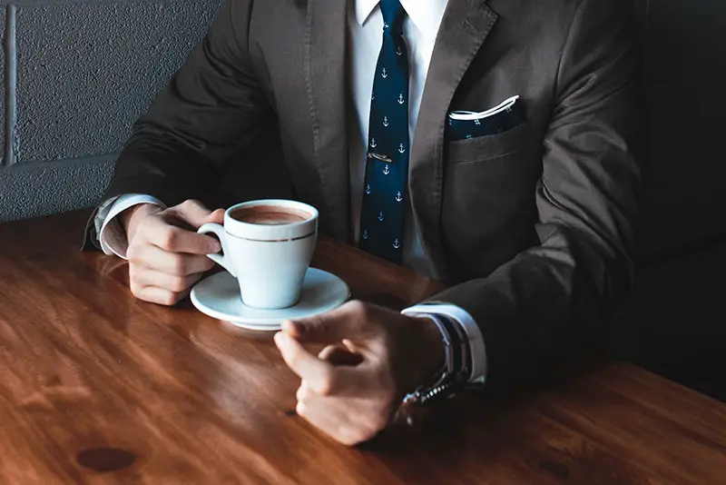 man taking coffee break – holding a cup of coffee
