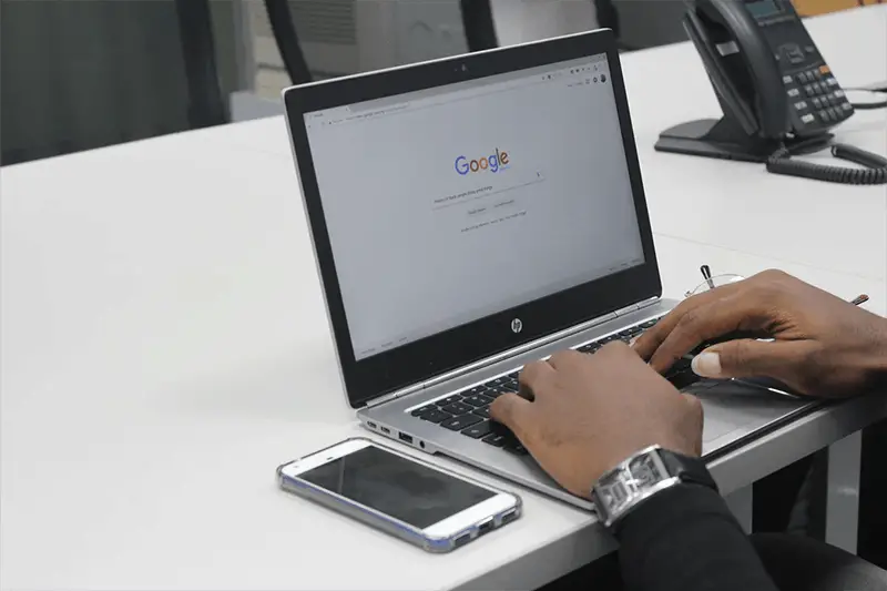 Person using a lpatop to do search on Google search engine 