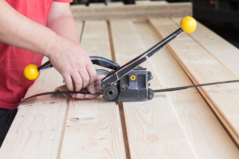 Close up of male warehouse worker fastening wooden planks in hardware store