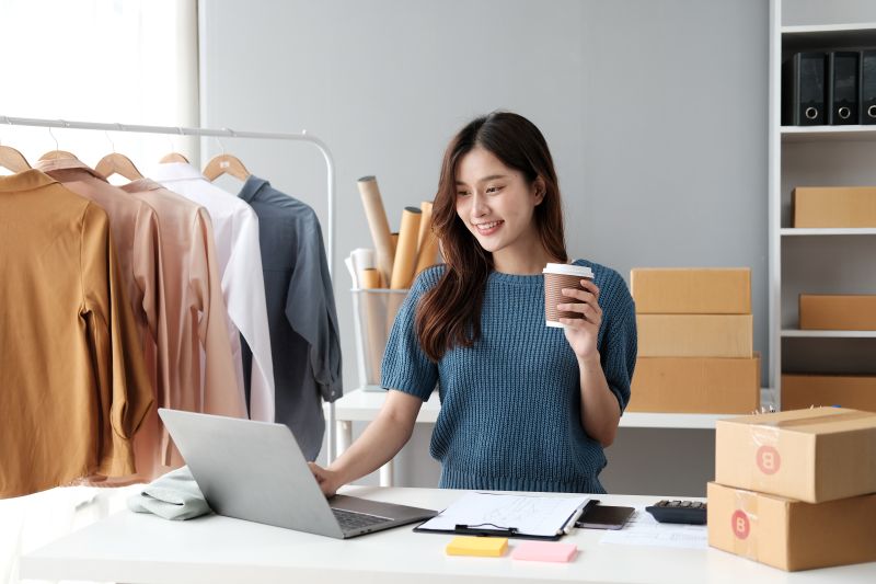 Woman Using Laptop at Workplace With Coffee
