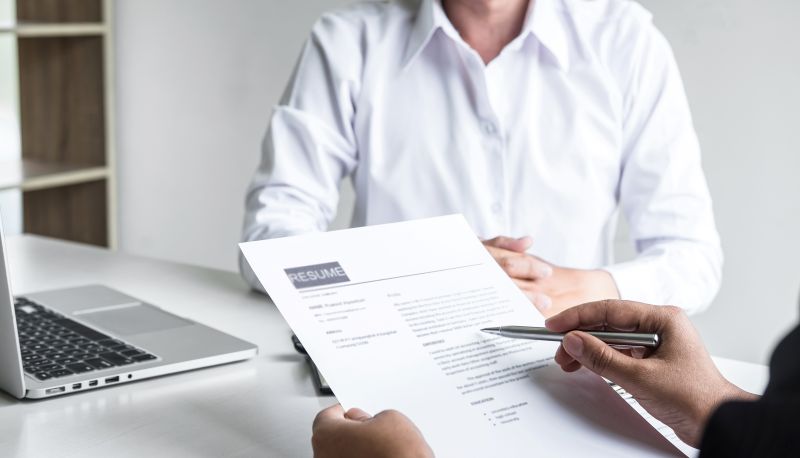 Resume Review with Potential Candidate at Desk