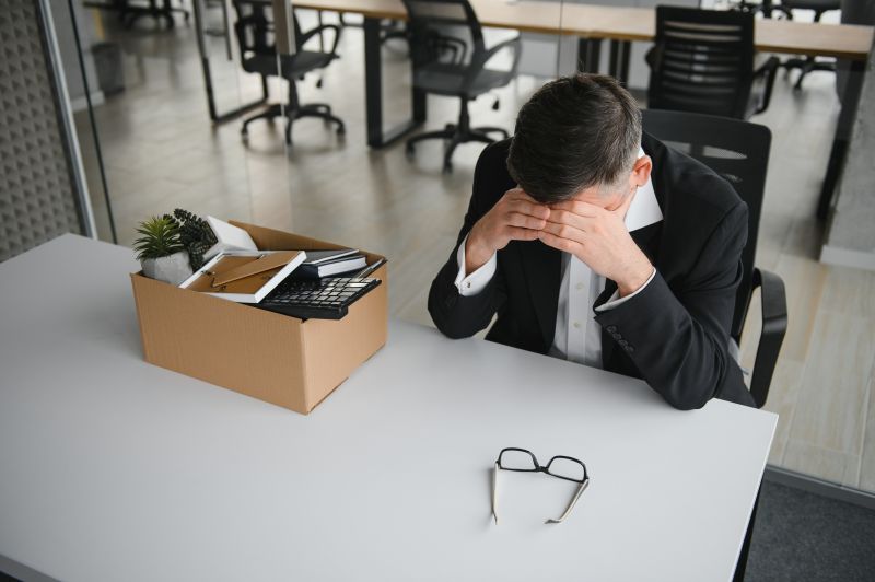 employee leaving office with the box full of belongings