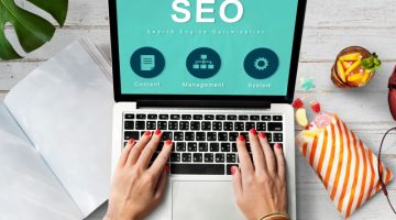 SEO on Laptop with Hand Typing in Workplace