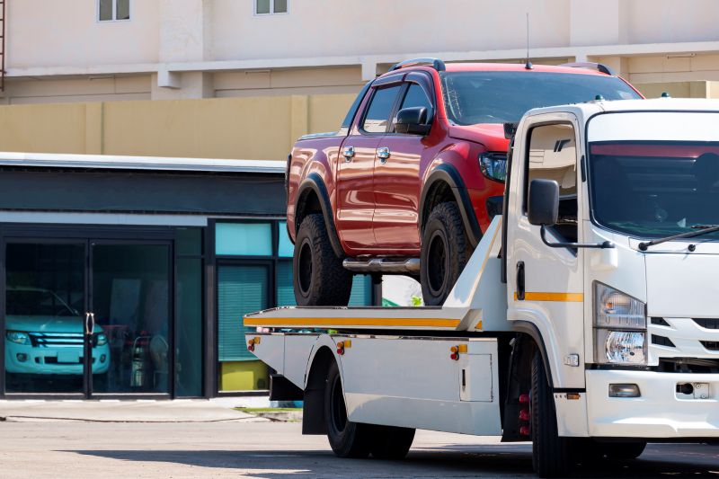 Red Pickup Truck Being Transported on Tow Truck