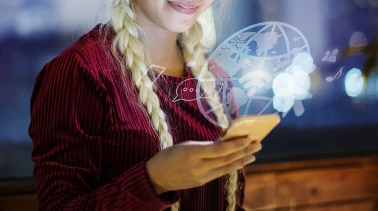 A woman wearing red long sleeves browsing on her smartphone