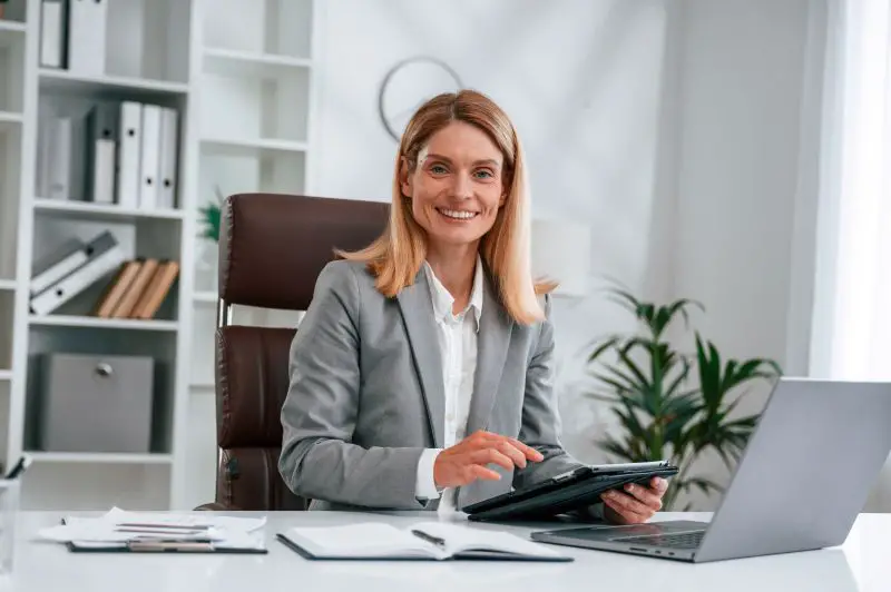 Woman in business formal clothes is working in office