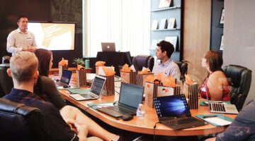 A group of people in a conference meeting